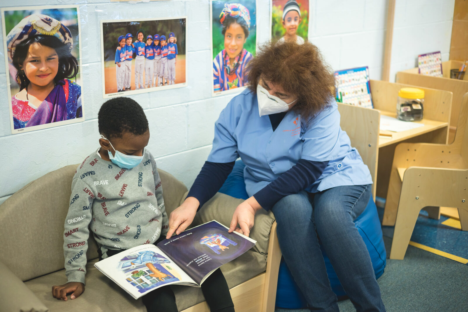 A teacher from the Carole Robertson Center for Learning's Albany Park flagship site reads to a child.
