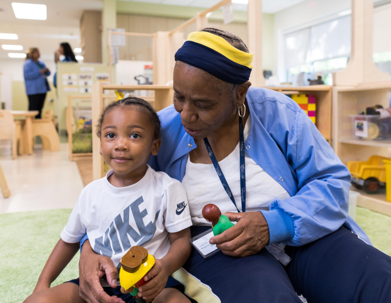 CRCL-ECE-staff CRCL staff member holding child